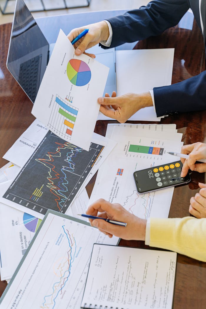 journey Business professionals analyzing financial charts and graphs during a meeting.